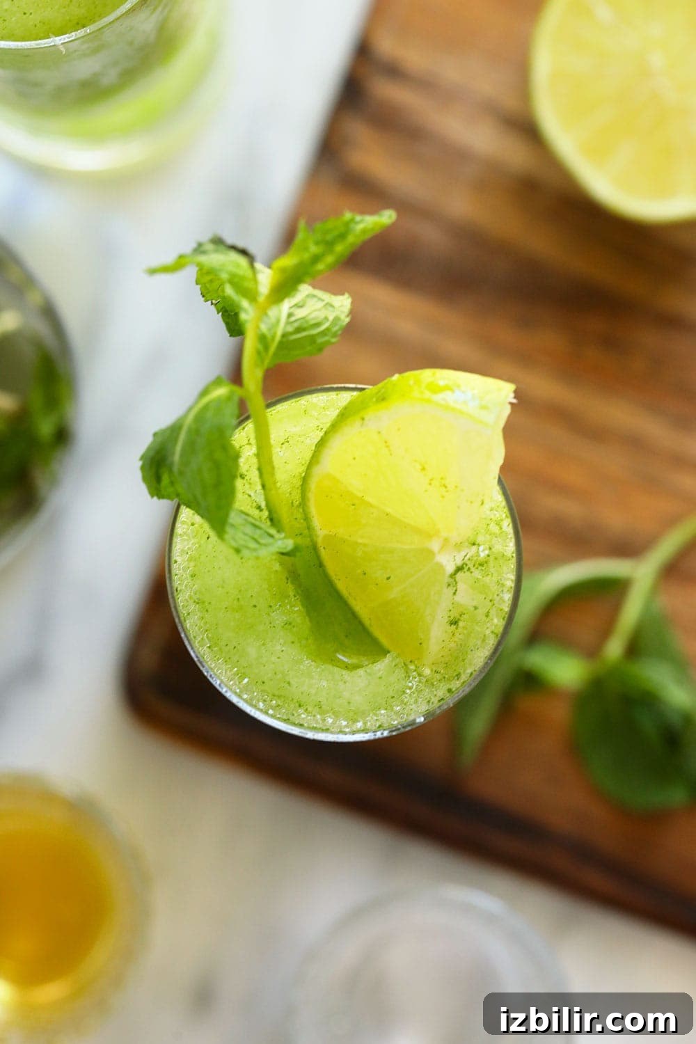 top down photo of frozen mojito with fresh mint and lime