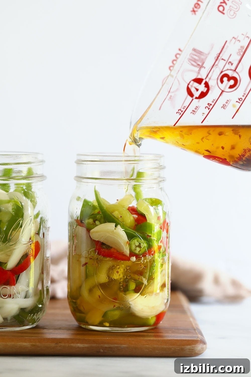 Quick Pickled Hot Peppers Recipe 4 sliced peppers in a jar ready to be pickled