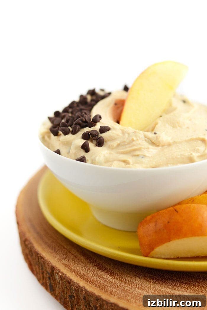 Peanut Butter Greek Yogurt Dip peanut butter greek yogurt dip in a bowl with chocolate chips