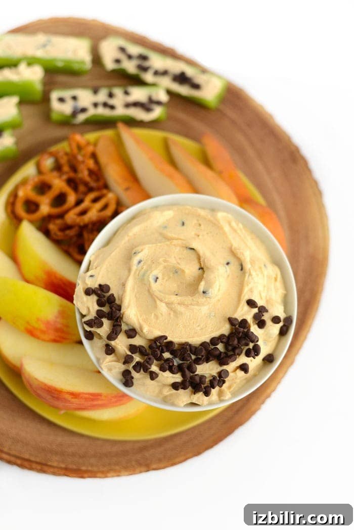 Peanut Butter Greek Yogurt Dip peanut butter greek yogurt dip with fruit and pretzels ready for dipping