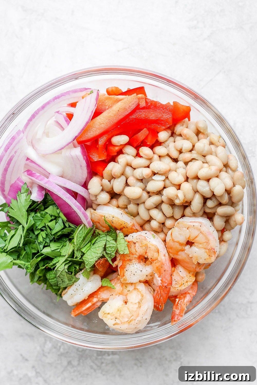 all ingredients for a healthy shrimp salad in a bowl before they're mixed together