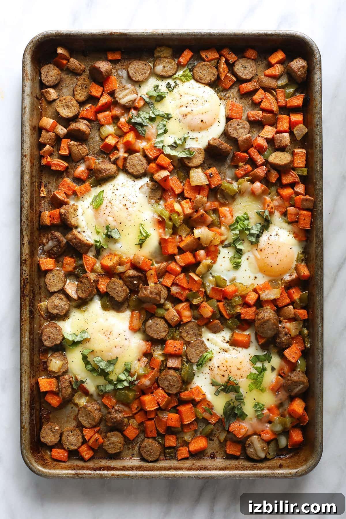 sheet pan with sweet potato hash and baked eggs