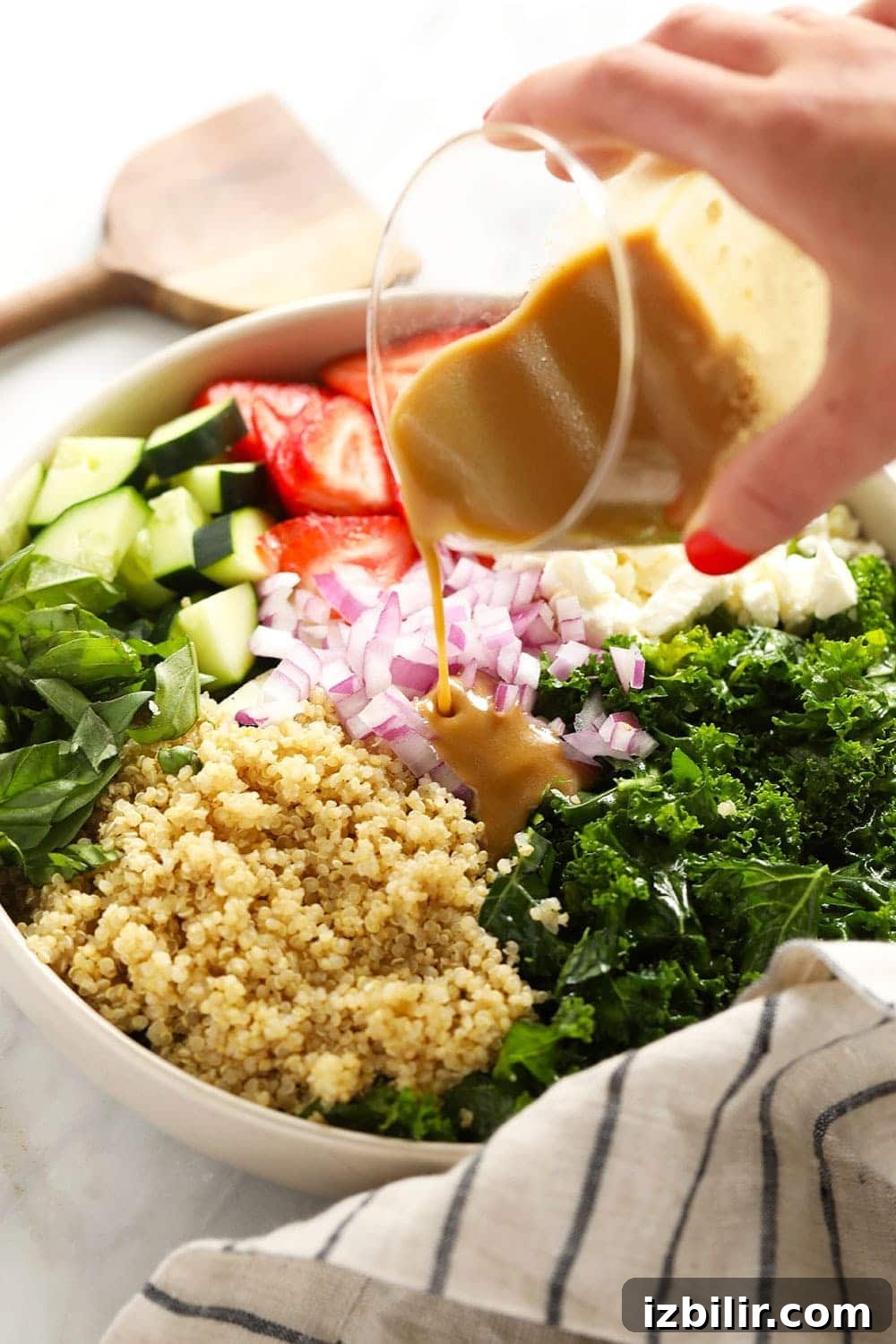 Close-up of salad ingredients: strawberries, quinoa, basil
