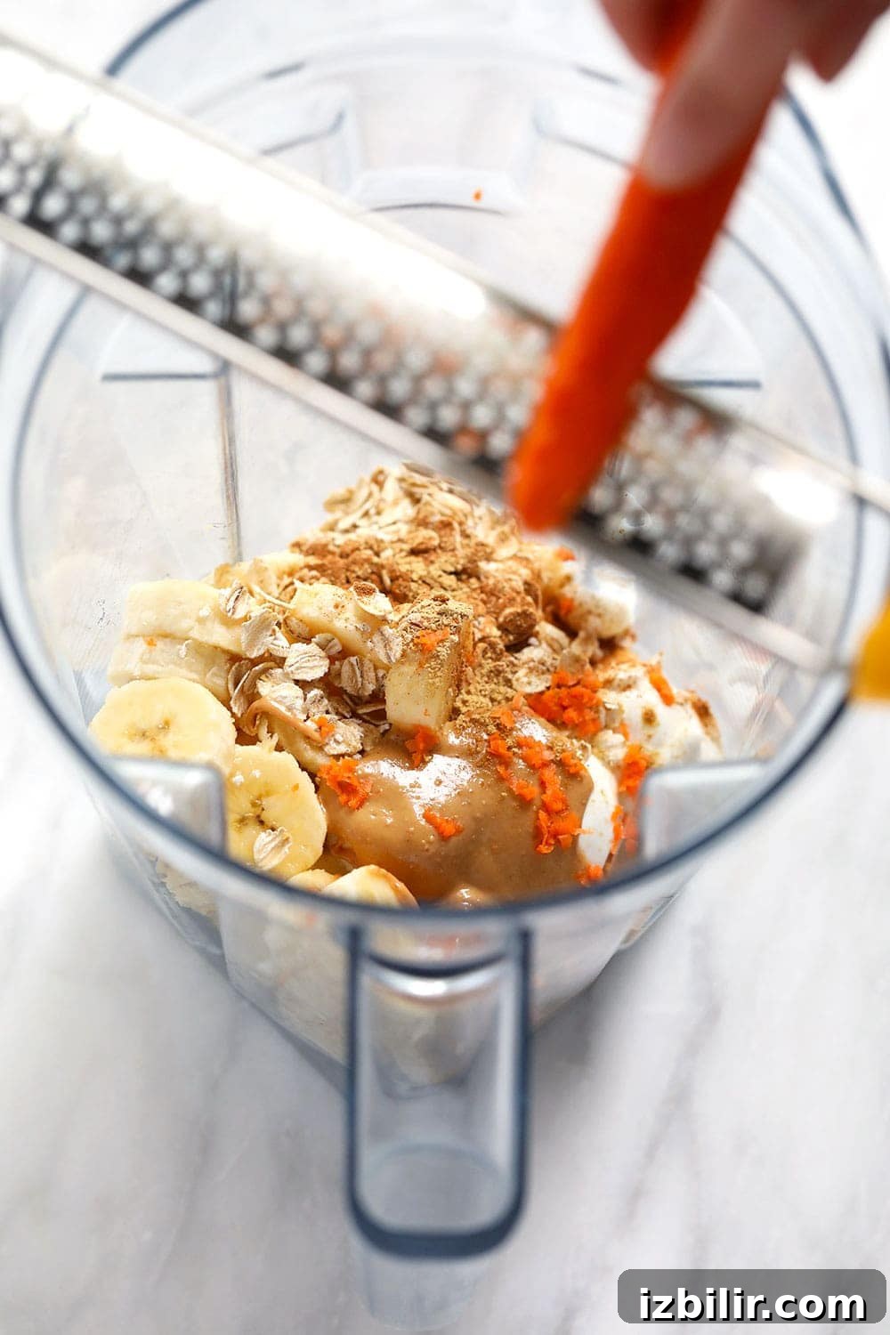 All the ingredients for a carrot cake smoothie in a vitamix.