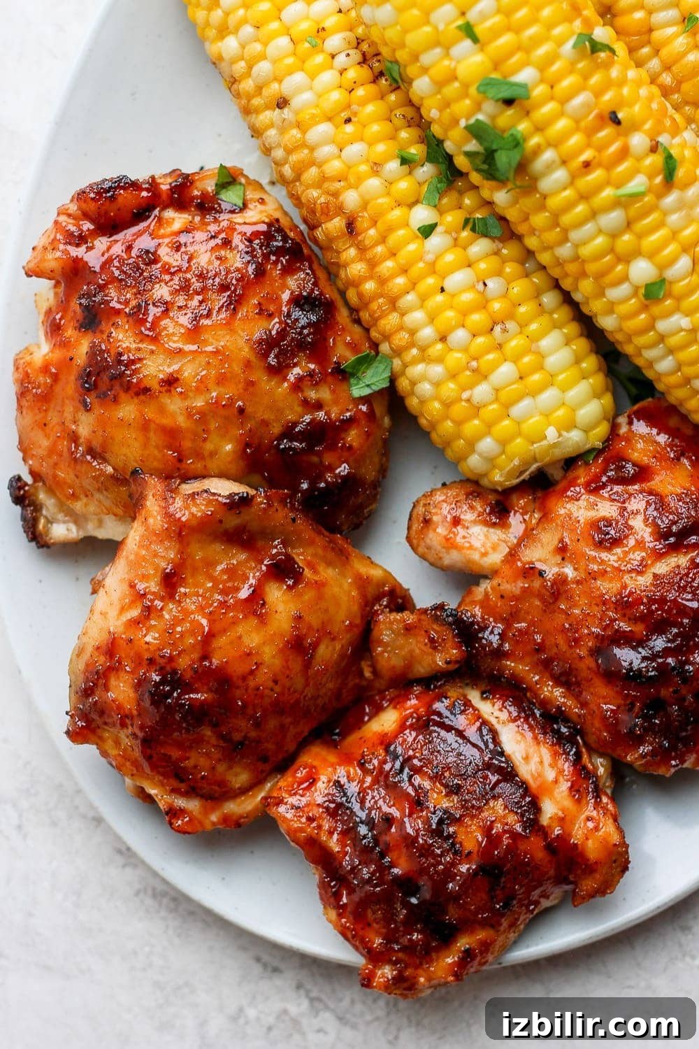Grilled chicken thighs with corn on a plate