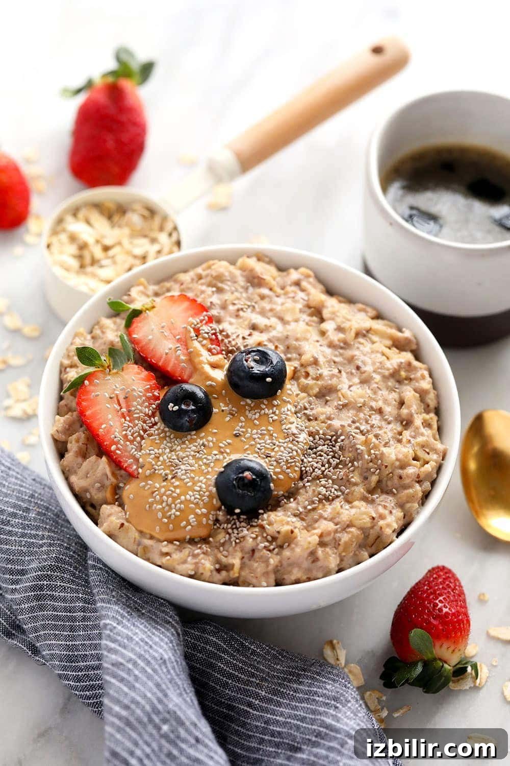 superfood oatmeal bowl topped with berries and nut butter