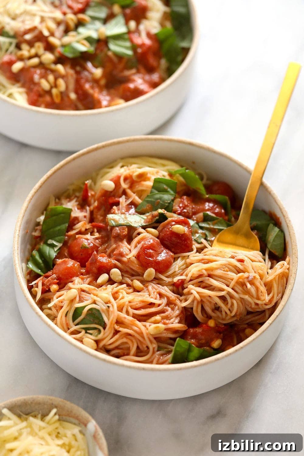 Summer Garden Pasta with Fresh Tomatoes and Herbs 2 Two bowls of garden summer pasta with fresh basil on top.
