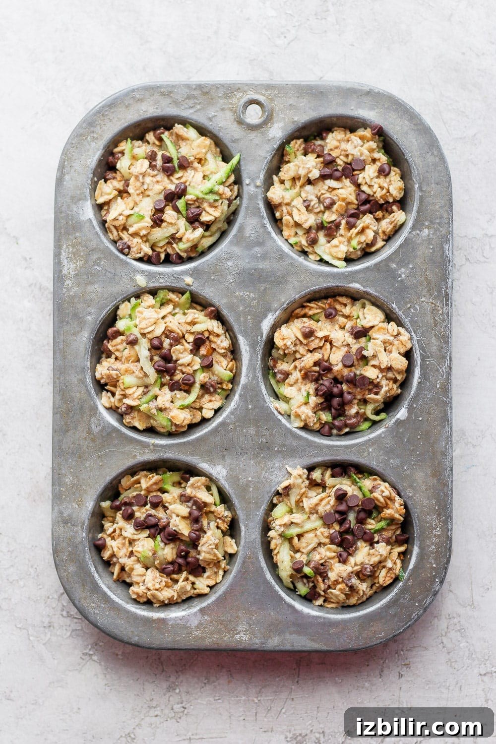 Brown Butter Chocolate Chip Zucchini Oatmeal Cups Recipe 4 Zucchini oatmeal cups in a muffin tin.