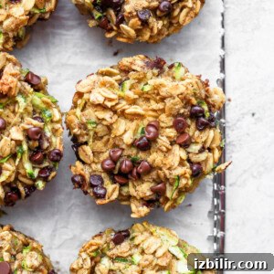 Brown Butter Chocolate Chip Zucchini Oatmeal Cups Recipe 7 zucchini chocolate chip muffins on a baking sheet.