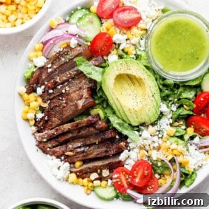 Grilled Chicken Salad with Avocado and Lemon Vinaigrette 2 Steak salad in a bowl with dressing.