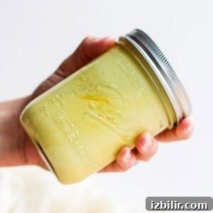Grilled Chicken Salad with Avocado and Lemon Vinaigrette 4 Hand shaking jar of honey mustard dressing.