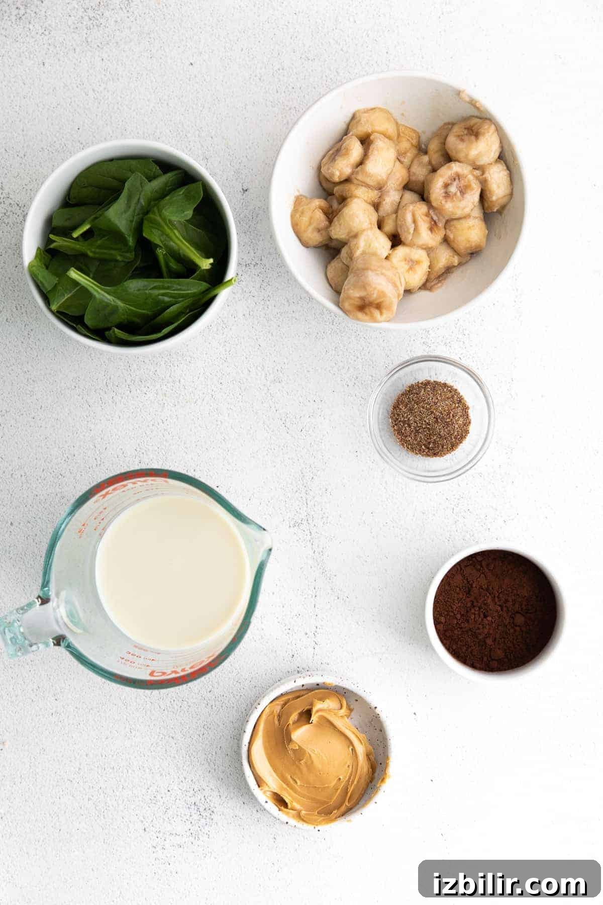 This Chocolate Peanut Butter Banana Smoothie is packed with protein and even has a full serving of greens in it. The best part is, it's healthy and tastes exactly like a peanut butter cup! smoothie ingredients on countertop