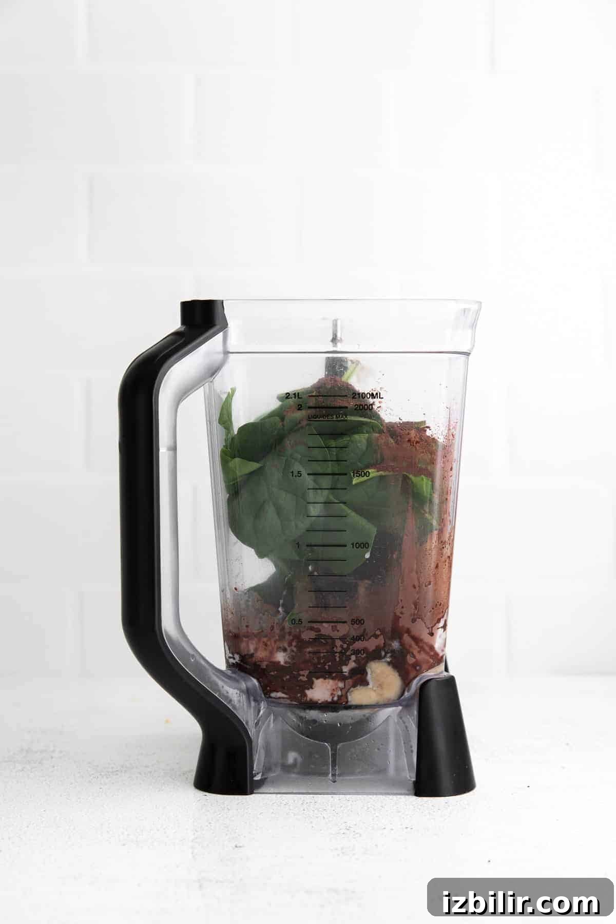 This Chocolate Peanut Butter Banana Smoothie is packed with protein and even has a full serving of greens in it. The best part is, it's healthy and tastes exactly like a peanut butter cup! smoothie ingredients in blender