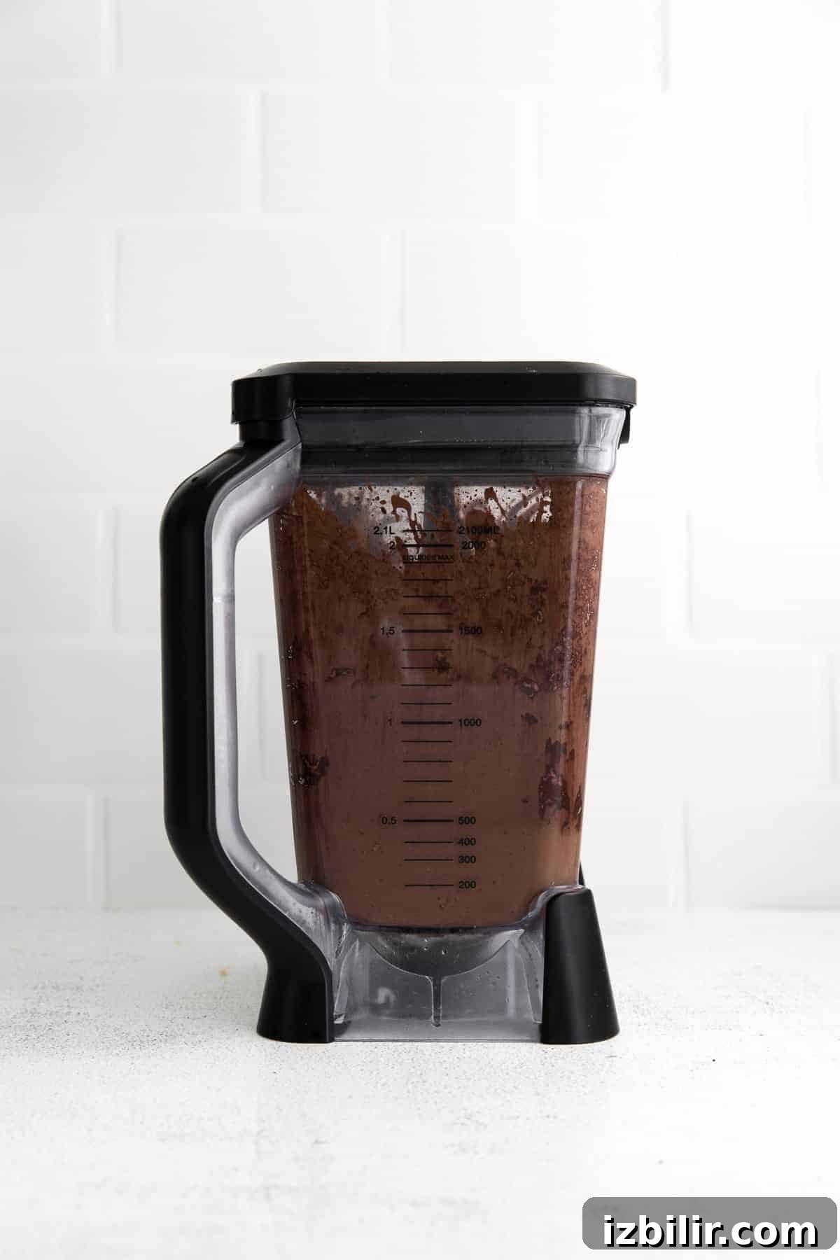 This Chocolate Peanut Butter Banana Smoothie is packed with protein and even has a full serving of greens in it. The best part is, it's healthy and tastes exactly like a peanut butter cup! chocolate smoothie blended in blender