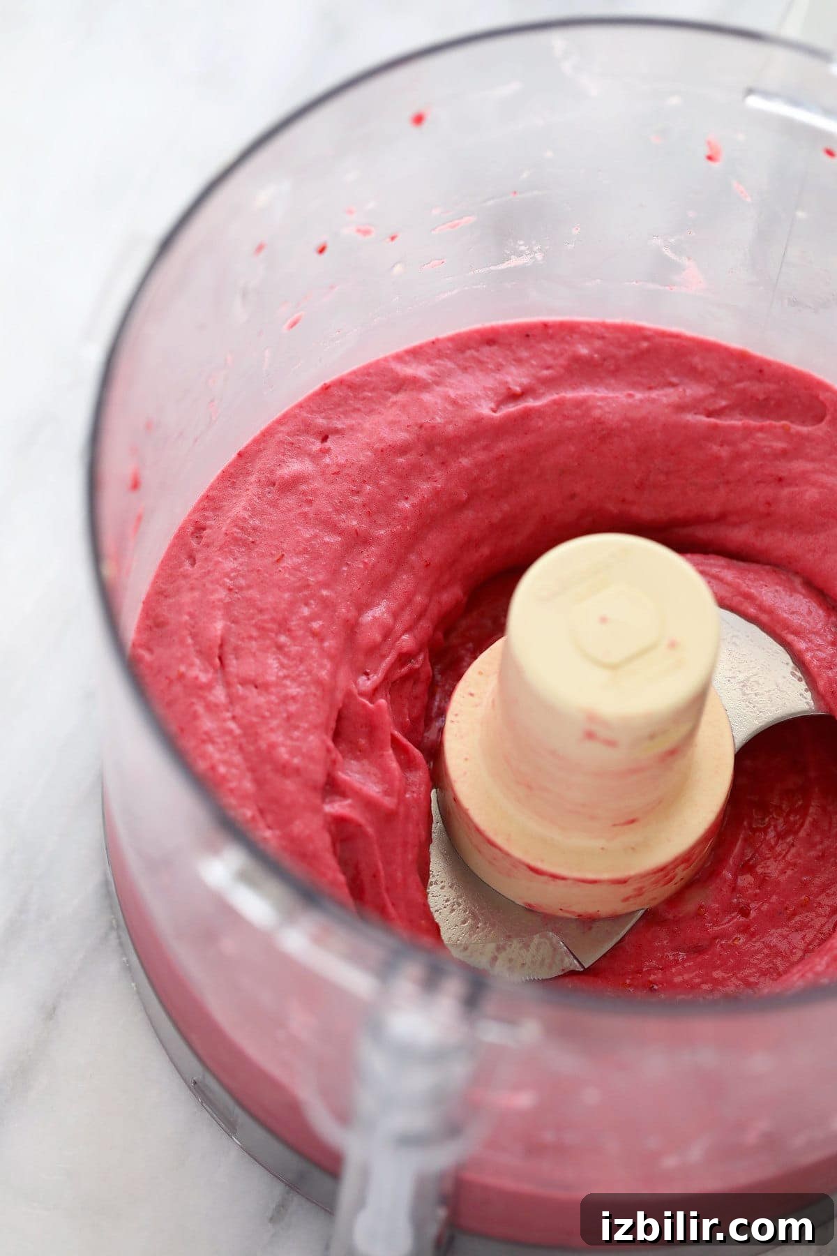 raspberry banana nice cream in a food processor blended to perfection