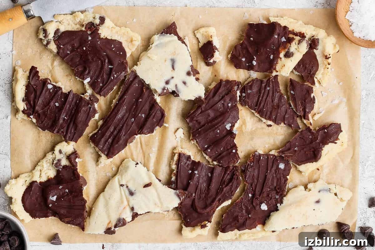 Cottage Cheese Cookie Dough Recipe Without Protein Powder 2 cottage cheese cookie dough bark broken into pieces on parchment paper