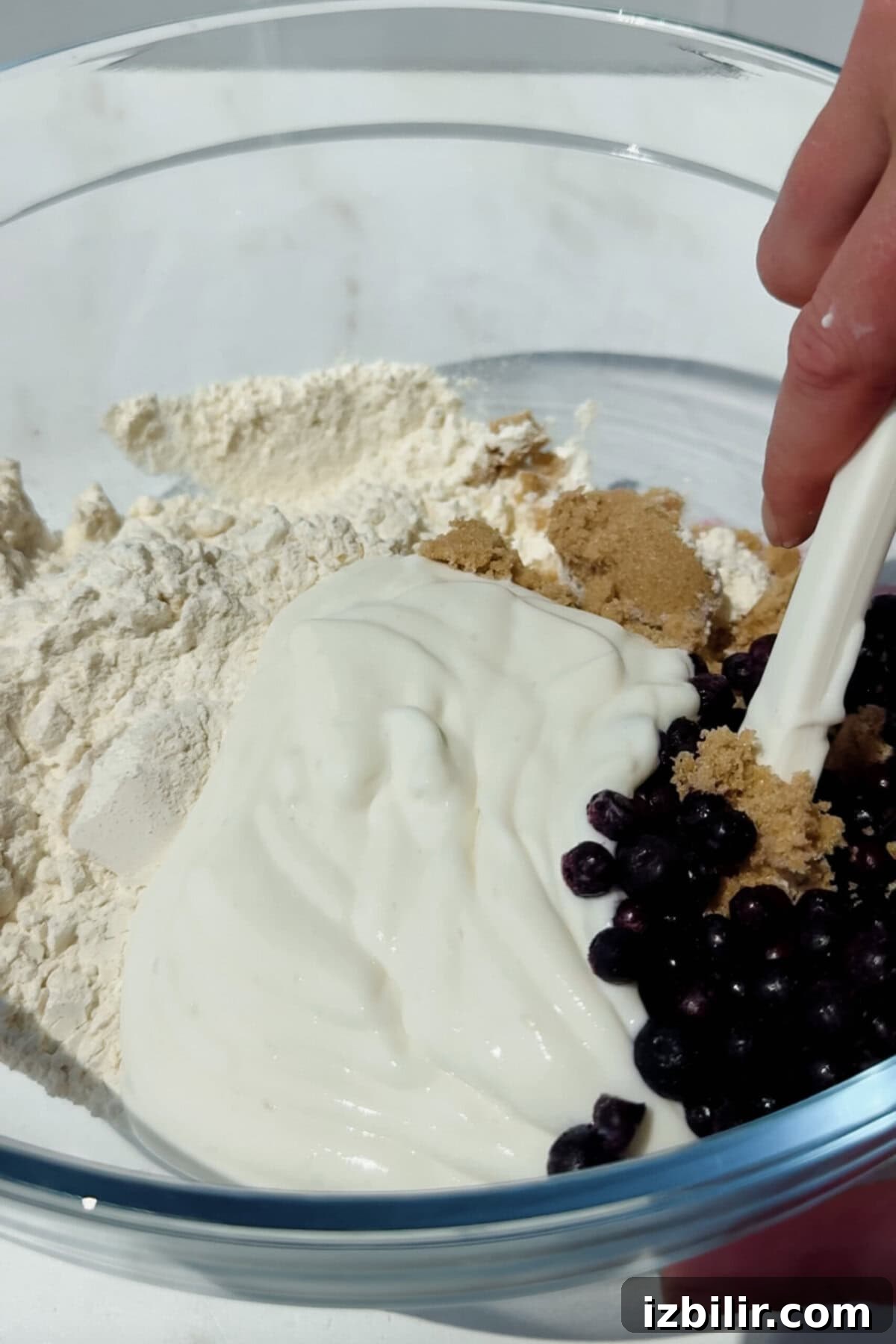 Buttery Blueberry Cottage Cheese Biscuits with Streusel 3 mixing flour cottage cheese blueberries and brown sugar in a bowl for blueberry biscuits