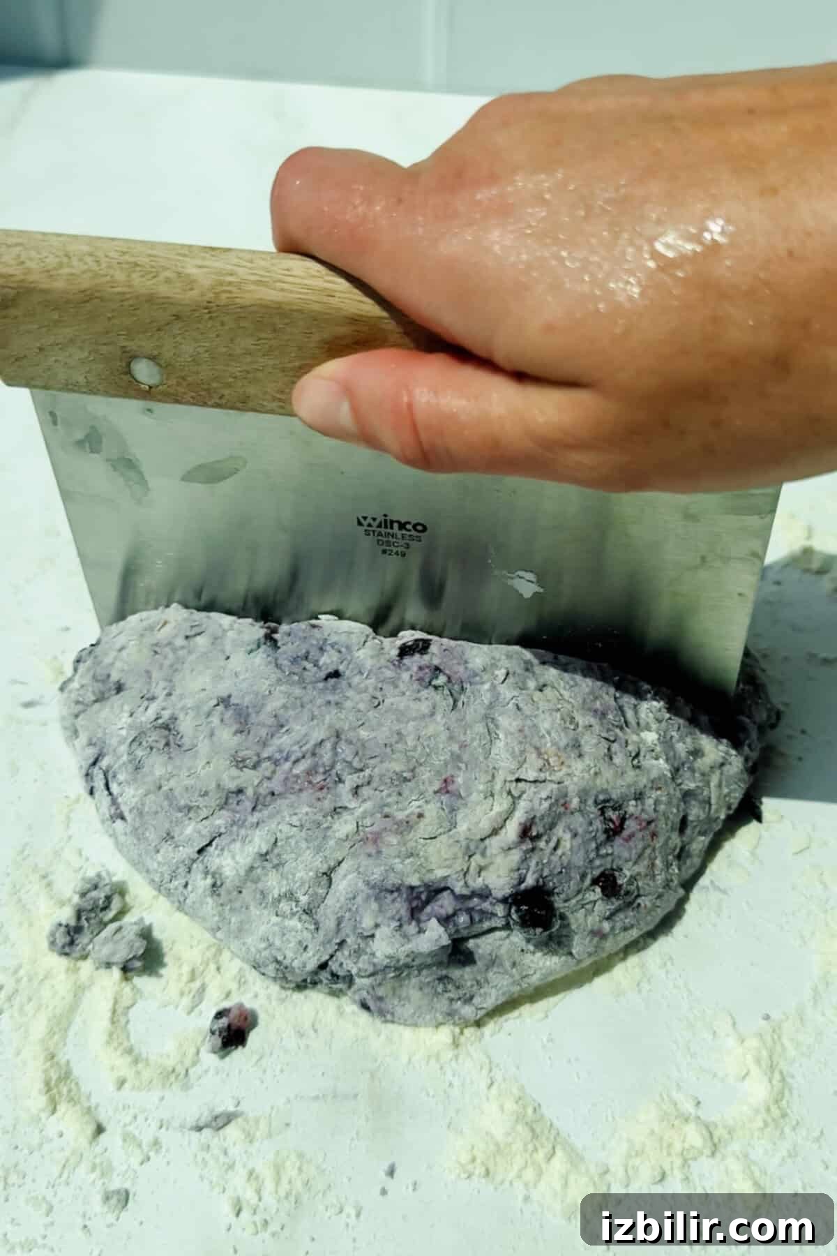 Buttery Blueberry Cottage Cheese Biscuits with Streusel 4 cutting blueberry biscuit dough on a floured surface with a dough scraper
