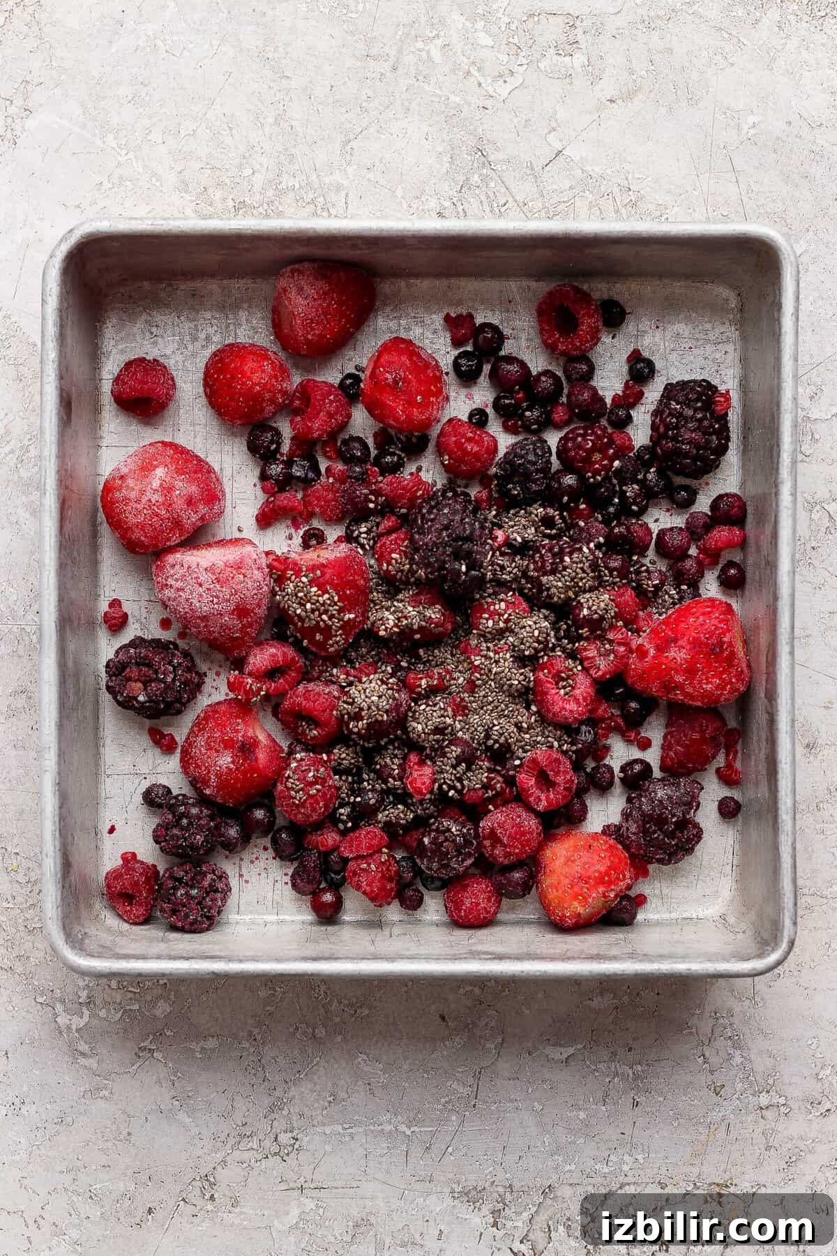 Peanut Butter & Jelly Protein Breakfast Crumble 3 frozen mixed berries tossed with chia seeds spread in a baking pan for protein berry crumble