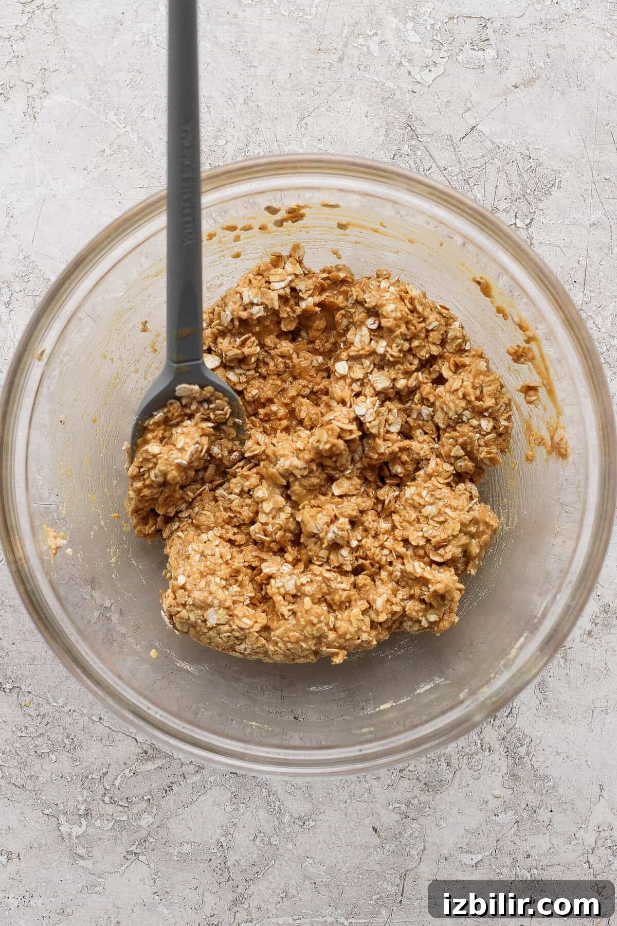 Peanut Butter & Jelly Protein Breakfast Crumble 5 stirring peanut butter oat crumble topping with a spatula until clumpy