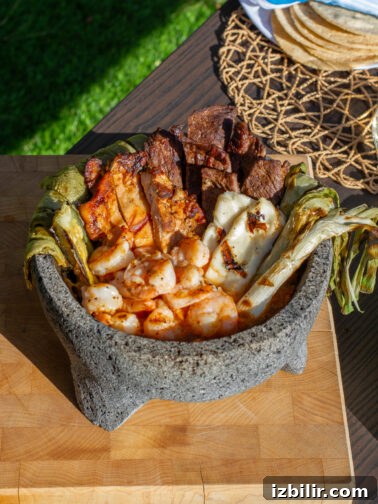 Molcajete Mixto sizzling on the table