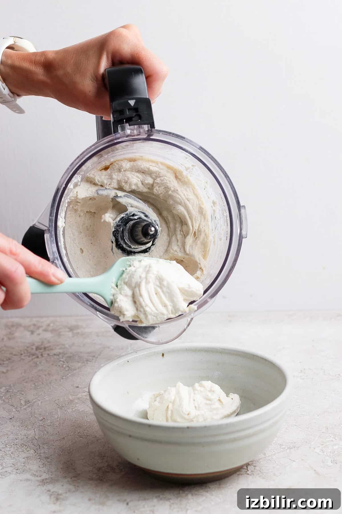 scooping blended apple dip into serving bowl
