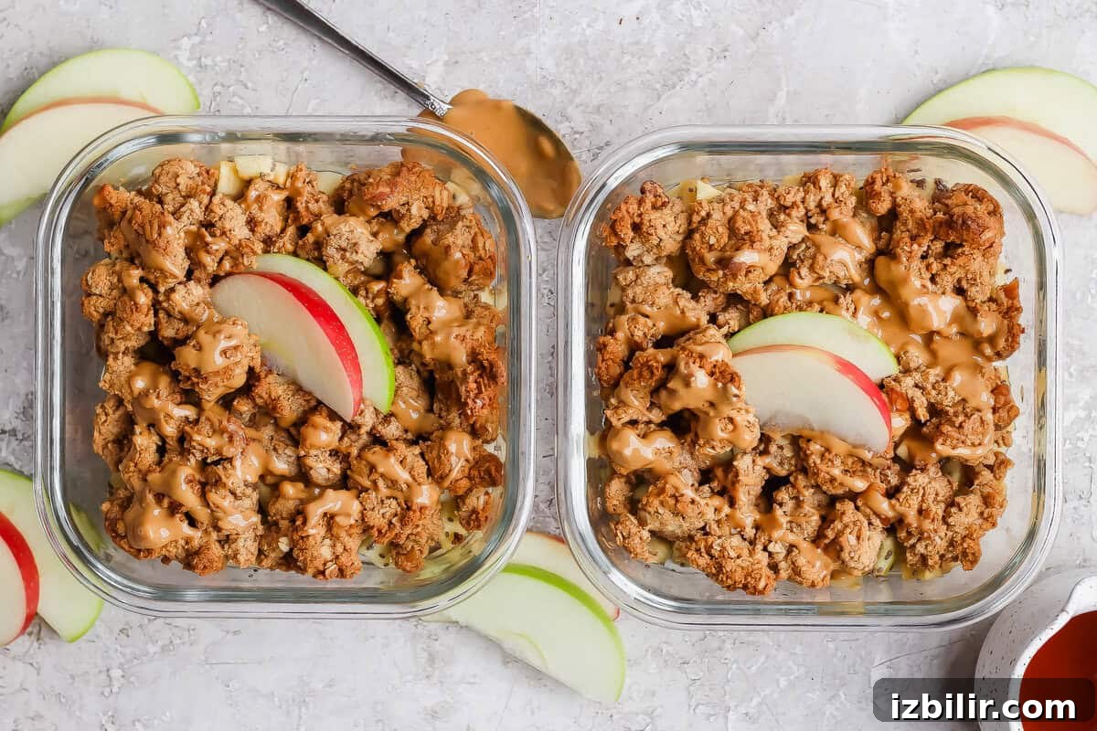 Two individual protein apple crisps topped with nut butter and sliced apples.