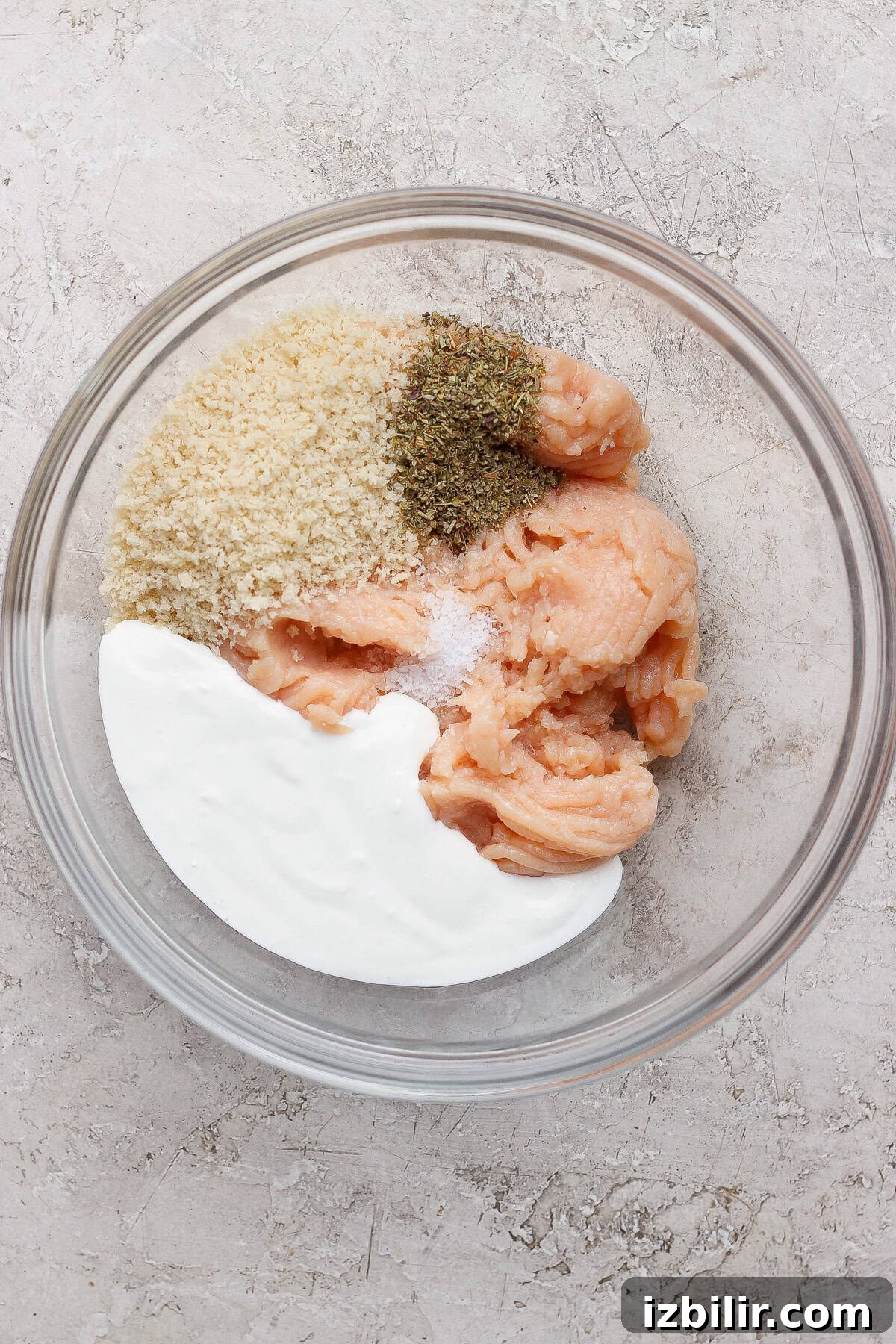 Bite-Sized Cottage Cheese Meatballs with Pasta 3 Ground chicken, panko, blended cottage cheese, Italian seasoning, and salt in a glass mixing bowl.