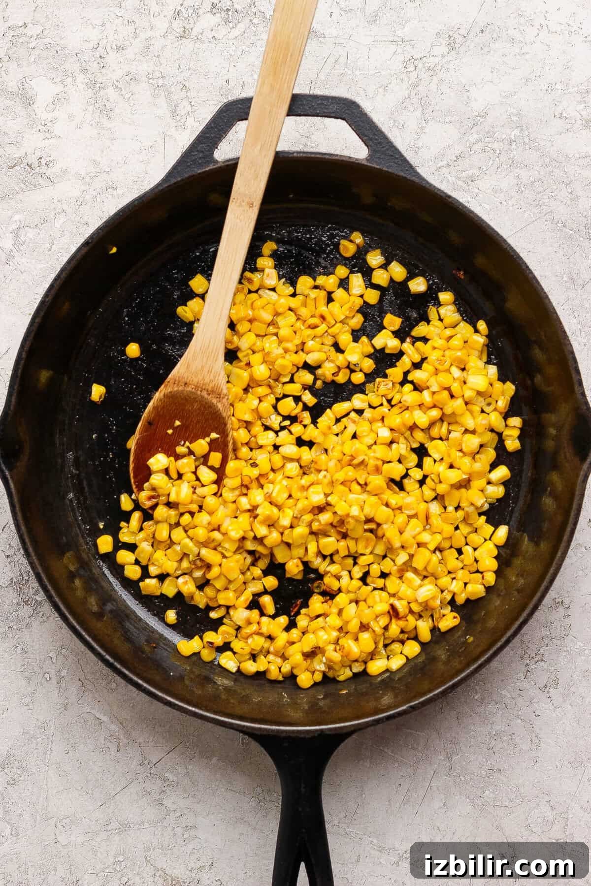 Oven-Baked Street Corn Chicken Tacos 3 Sweet corn kernels browning in avocado oil in a cast-iron skillet.