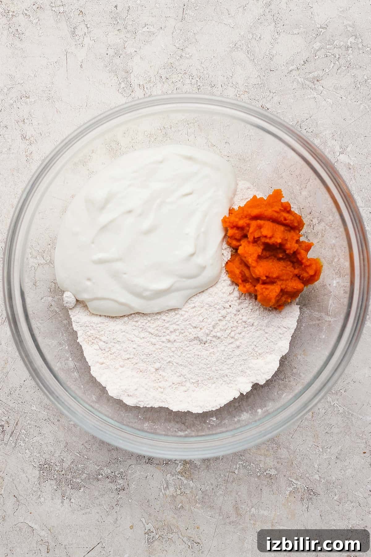 Crispy Cottage Cheese Pumpkin Fritters Recipe 3 Blended cottage cheese and pumpkin puree added to the flour mixture in a glass bowl.