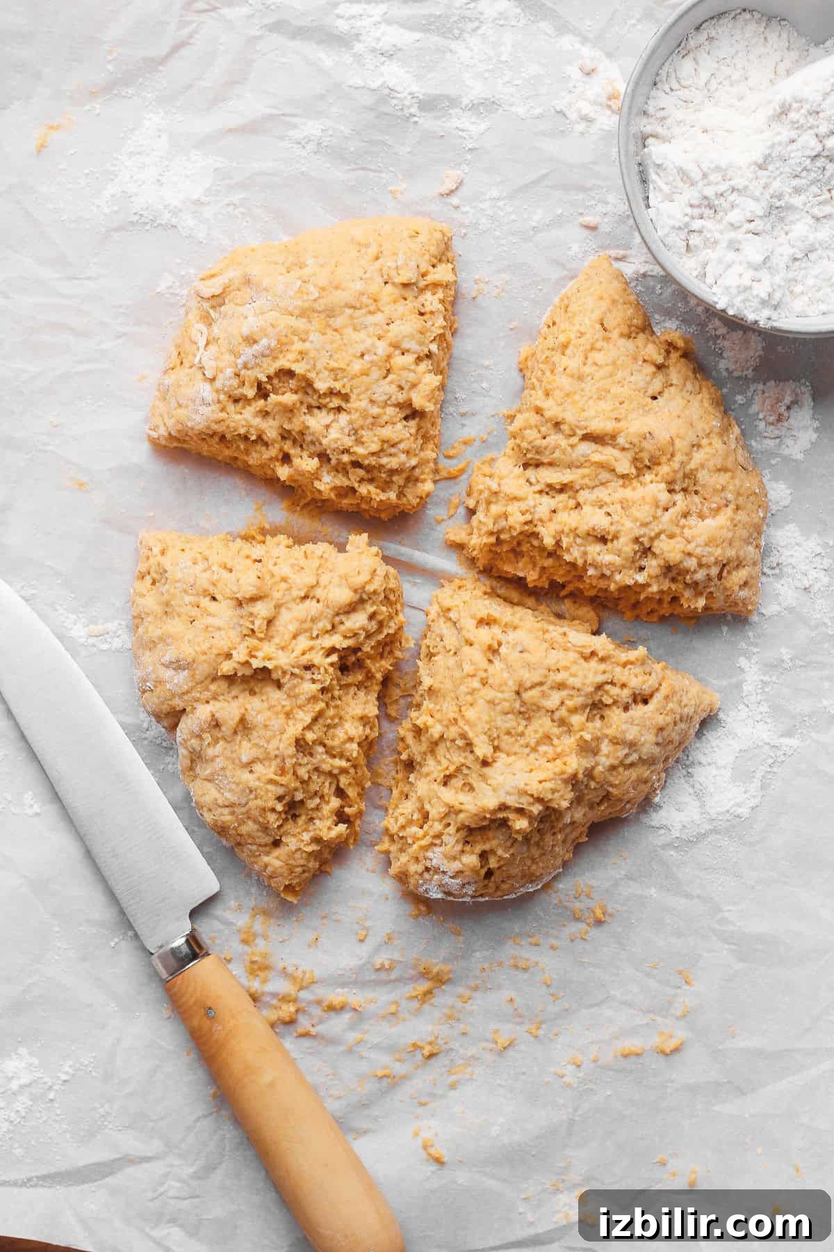 Crispy Cottage Cheese Pumpkin Fritters Recipe 5 Pumpkin fritter dough cut into four equal wedges on a lightly floured work surface.