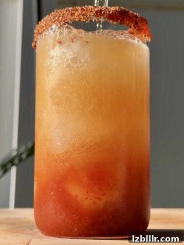 Classic michelada in a glass with Tajín rim and lime