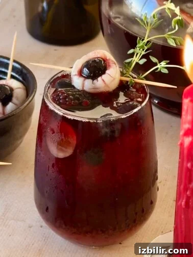 Pitcher of dark sangria with lychee eyeball garnish