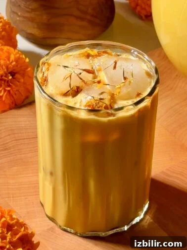 Glass pitcher of golden horchata made with cempasúchil petals and cinnamon